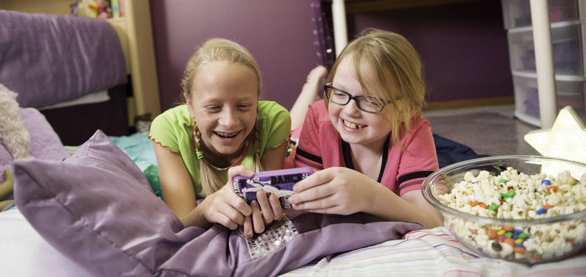 two girls looking at a cell phone