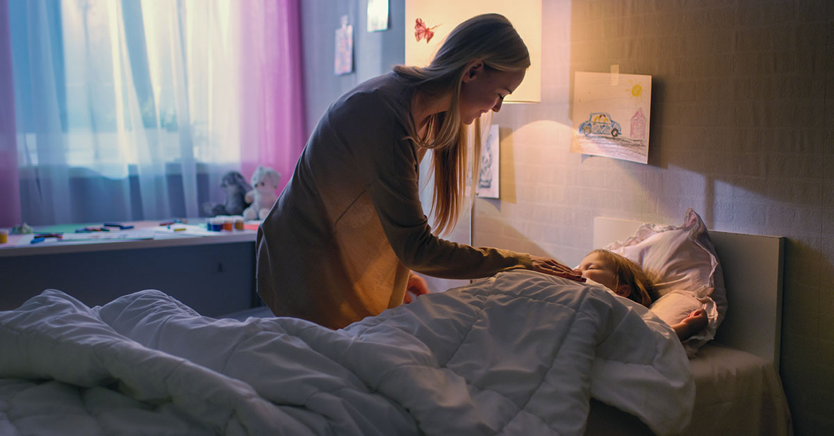 mom tucking in daughter