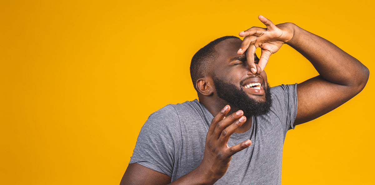 man pinching nose